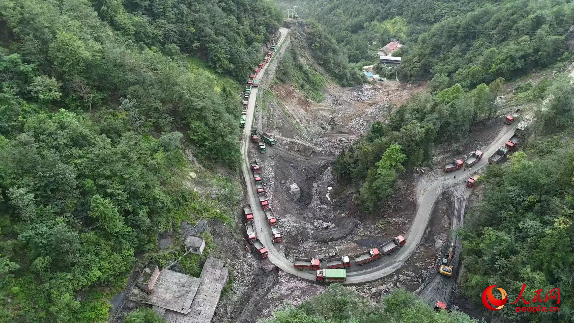 清運礦渣的卡車停在工區(qū)。受訪者供圖